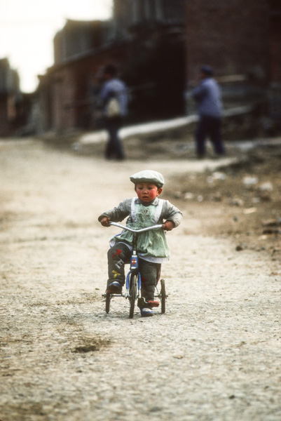 Child on tricycle