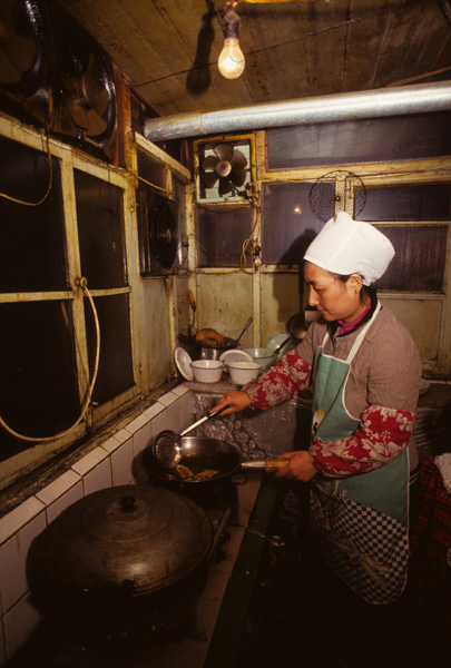 Woman cooking at Li Family Restaurant