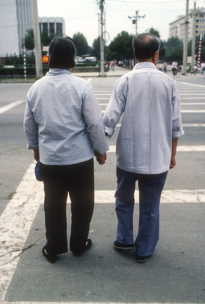 Couple crosses the street