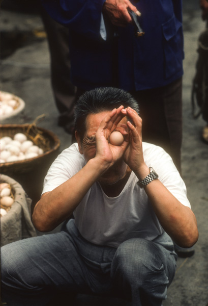Man checking eggs for freshness