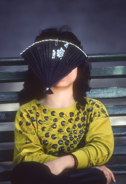 Woman napping with fan over face