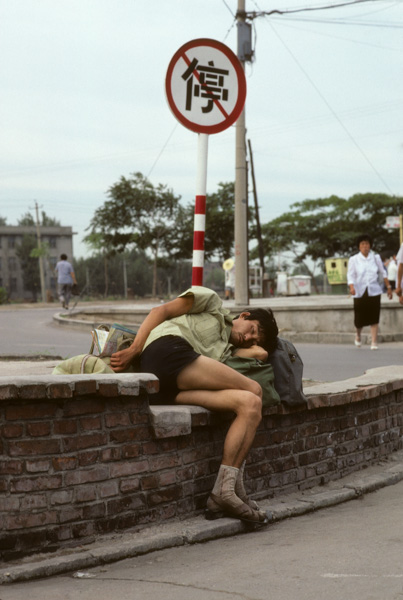 Man sleeping by no parking sign