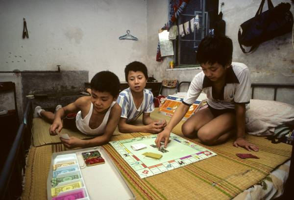 Boys play Monopoly at acrobat school