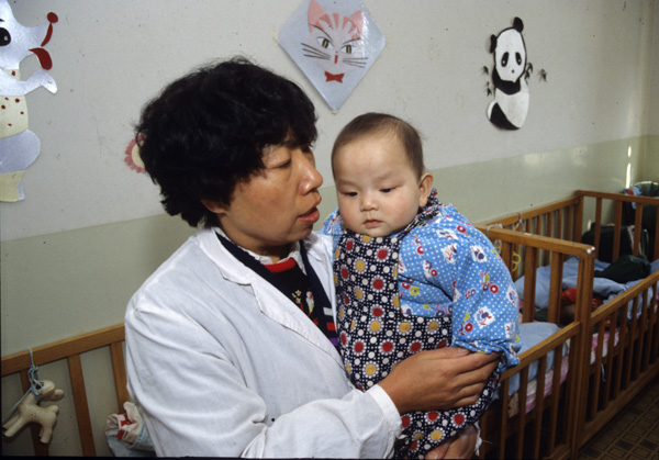Baby and nurse in orphanage