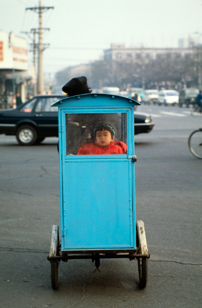 Child in enclosed cart, Beijing, China