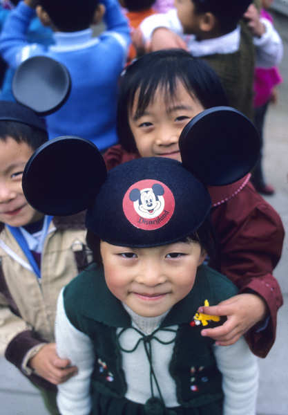 Child in Mickey Mouse hat