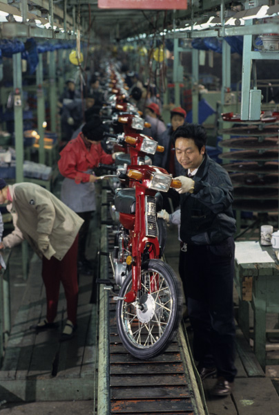 Workers assemble Yamaha motorcycles