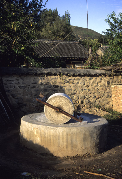 Millstone in village