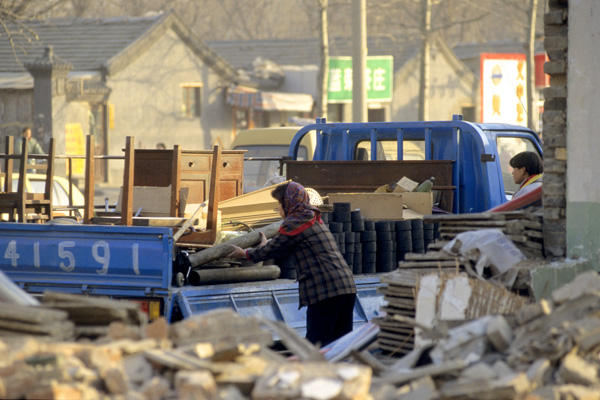 Family loads belongings as neighborhood is demolished