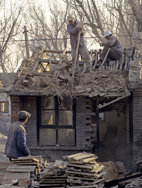 Workers demolish hutong house