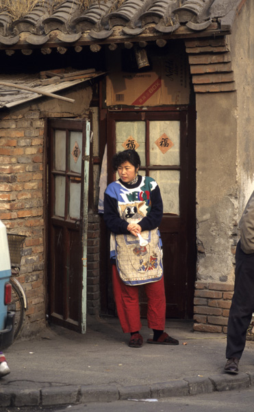 Aproned woman in hutong