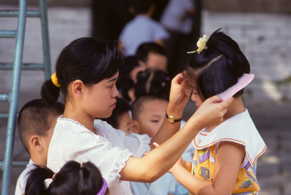 Child, teacher at kindergarten