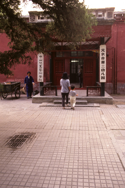 Mother and child enter kindergarten