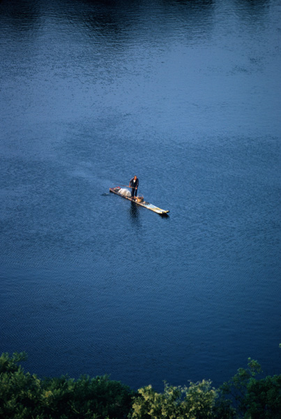 Fisherman on bamboo raft