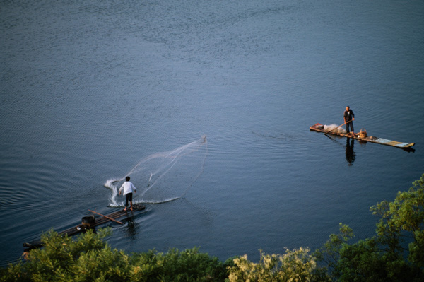 Men fishing on rafts,  Li River near Guilin, China