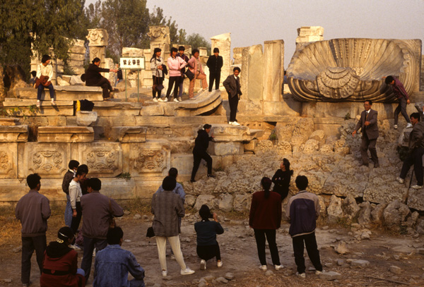 Visitors climb on the ruins at the Old Summer Palace