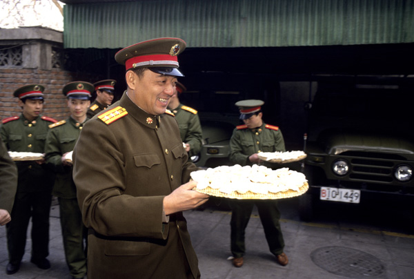 Soldiers hold dumplins for elderly