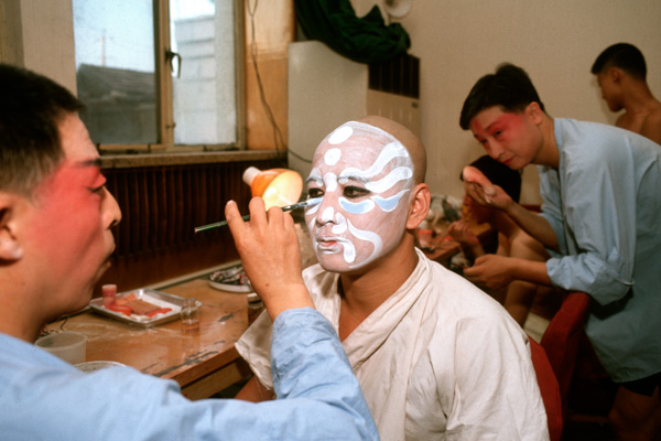 Peking opera actors apply makeup