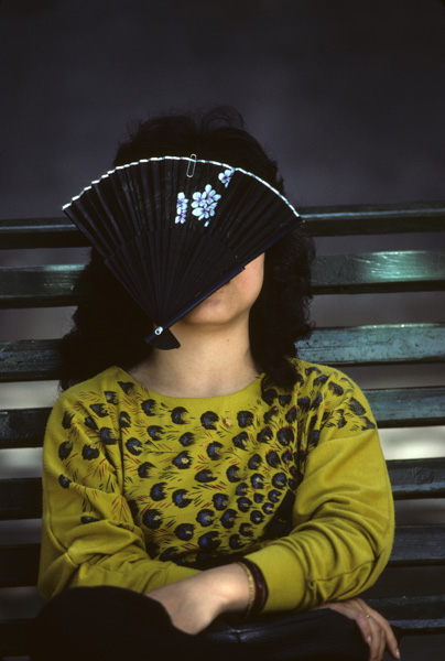 Woman with fan over face, Beijing