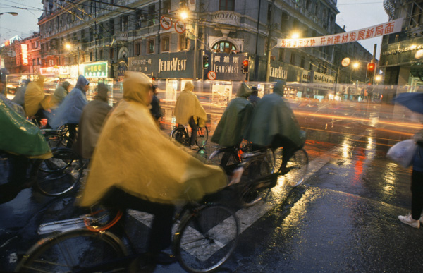 Bicyclists in rain in Shanghai