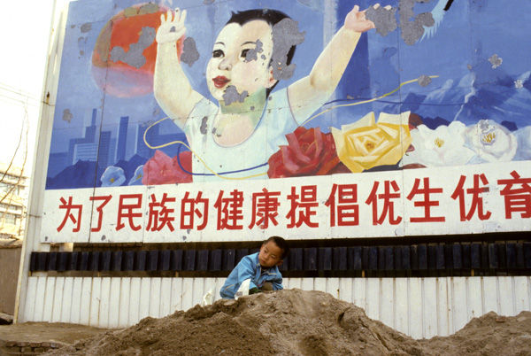 Child with population control billboard