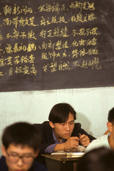 Student sharpens pencil, Beijing