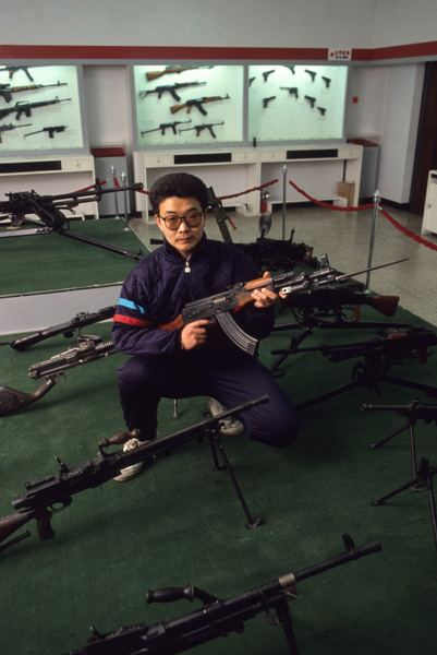 Worker with weapons at shooting range