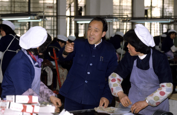 Head of state-run factory with workers