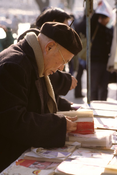 Man and book at stand, Beijing