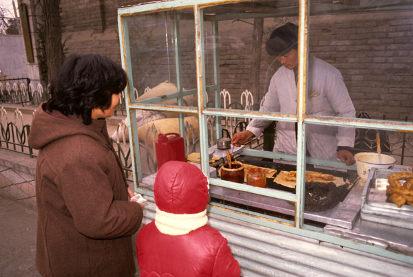 Vendor making onion pancakes