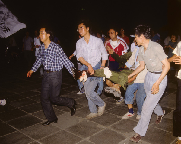 Protesters carry injured soldier