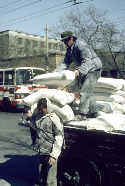 Workers unload flour