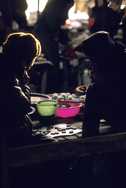 Men playing chess in market