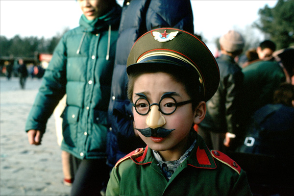 Child in mustache and army uniform, China