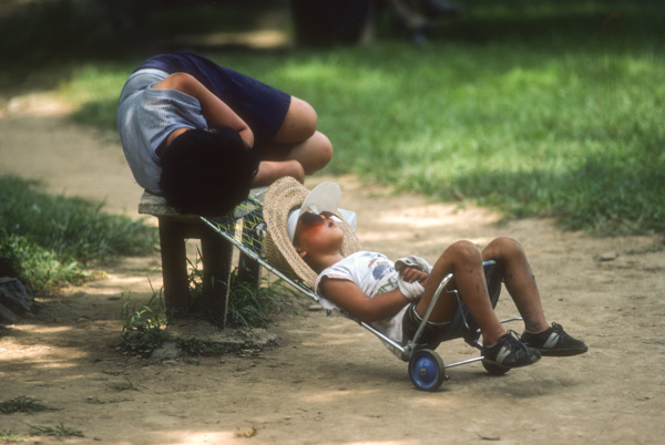 Woman and child nap in park