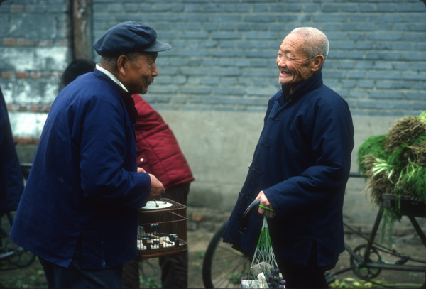 Two men chat in Chinese market