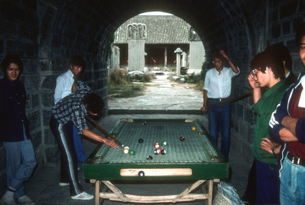 Men playing pool at historic site