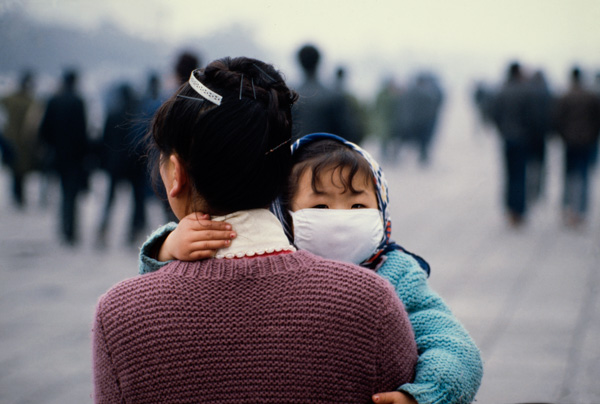 Woman and masked child