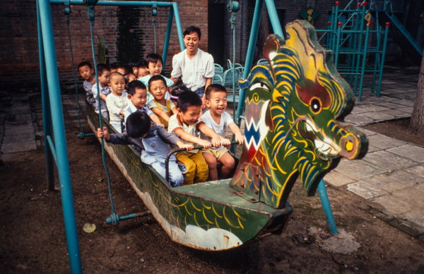 Children on dragon swing, Beijing