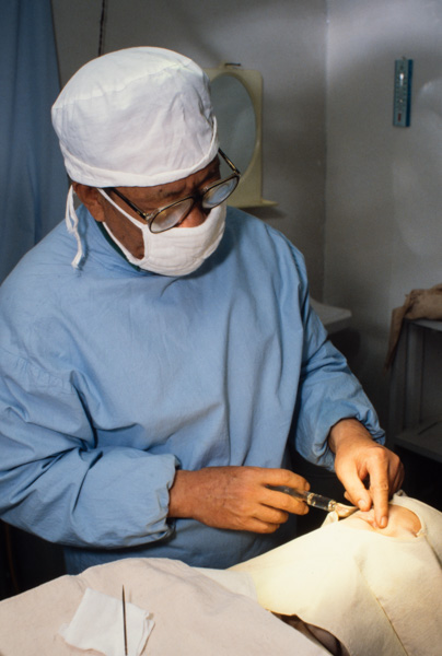Doctor performing eyelid surgery