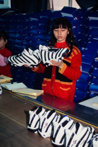 Worker inspects Reebok shoes, China