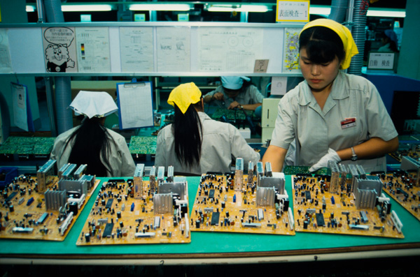 Women workers assemble motherboards