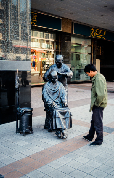 Street barber statue, China