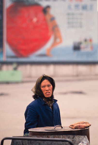 Sweet potato vendor and bikini billboard, China