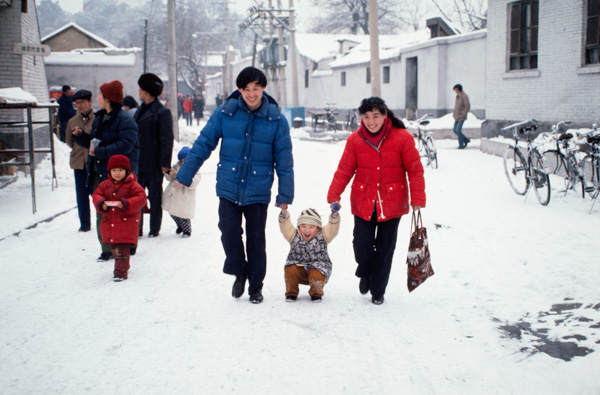 Couple and child in snow, Beijing