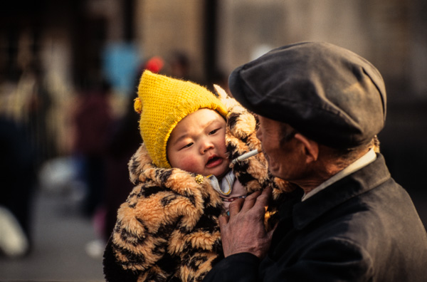 Man smokes while holding child