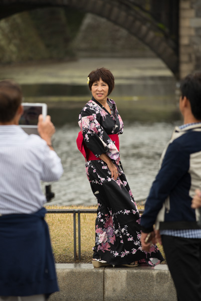 Woman in kimono with bridge, Imperial Palace, Tokyo, Japan