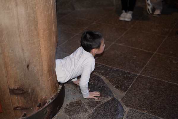 A Child Crawls Through a Pillar