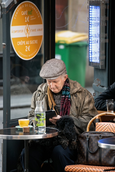 Man and dog at a sidewalk cafe, Montorgueil Street, Paris, France