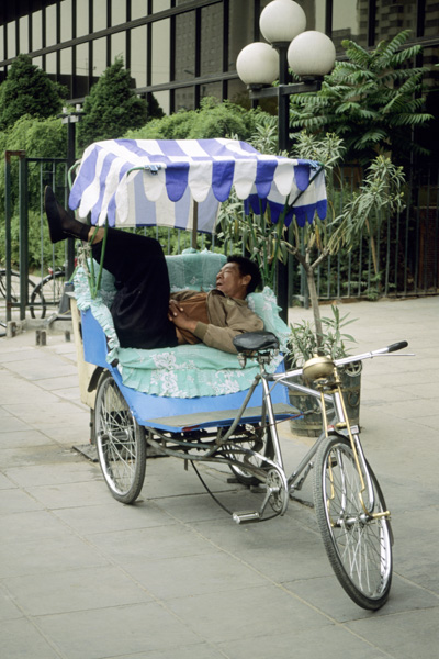 Pedicab driver resting